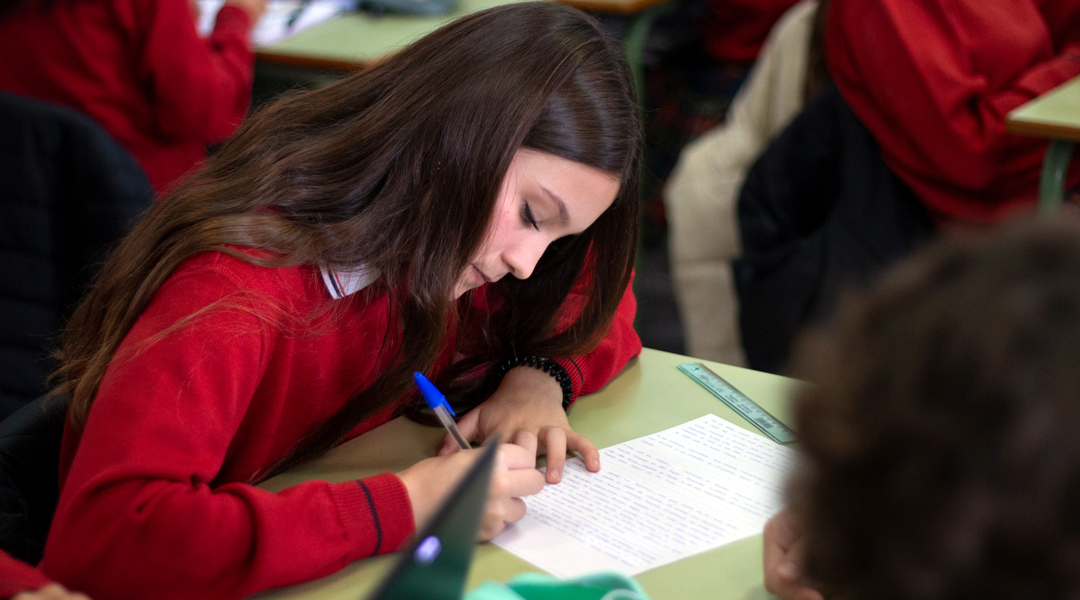 Alumna de Educación Primaria realizando actividades en su cuaderno.
